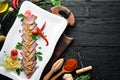 Boiled veal tongue with vegetables and spices on a plate. Restaurant dishes. Top view. Royalty Free Stock Photo