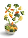 Boiled vegetables flying on white background. Creative concept