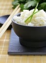 Boiled white rice in a black bowl Royalty Free Stock Photo