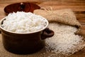 Boiled white rice in ceramic pot on wooden background. Royalty Free Stock Photo