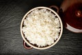 Boiled white rice in ceramic pot on wooden background. Royalty Free Stock Photo