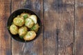 Boiled young potatoes with dill and butter on a wooden table, top view, closeup. rustic style Royalty Free Stock Photo