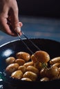 Boiled young potatoes with oil and roasted garlic, in a wooden dish. Royalty Free Stock Photo