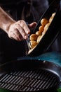 Boiled young potatoes with oil and roasted garlic, in a wooden dish. Royalty Free Stock Photo