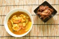 Boiled zhrimp and mixed vegetable in spicy and sour prange curry soup with fried pork belly in sweet gravy sauce Royalty Free Stock Photo