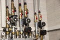 Heating of the house with a large number of steel pipes, pressure gauges and metal pipes, selective focus. Boiler and pipes of the