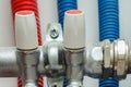 Boiler pipes and valves. Red and blue valves for cold and hot water Royalty Free Stock Photo