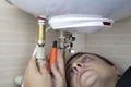 The boiler repairman checks the electronics in the water heater. Professional assistance and technical support concept