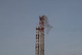 The boiler room chimney smokes against the blue sky Royalty Free Stock Photo