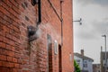 a boiler steam vent on the side of a brick house bellowing steam on a cold winter day Royalty Free Stock Photo