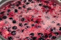 Boiling black currant and raspberry compote Royalty Free Stock Photo