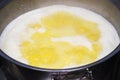 Boiling butter in a saucepan on a gas stove Royalty Free Stock Photo