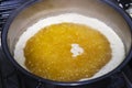 Boiling butter in a saucepan on a gas stove Royalty Free Stock Photo