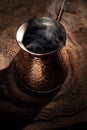 Boiling coffee in copper Turkish coffee brewing pot Royalty Free Stock Photo