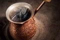 Boiling coffee in copper Turkish coffee brewing pot Royalty Free Stock Photo