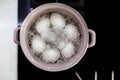 Boiling eggs with boiling water in the pot
