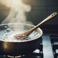 Boiling flat pot with a wooden spoon inside Royalty Free Stock Photo