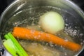 Boiling meat broth in steel stewpan close up Royalty Free Stock Photo