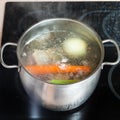 Boiling meat broth in stockpot on ceramic cooker Royalty Free Stock Photo