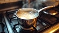 boiling milk in saucepan on the stove Royalty Free Stock Photo