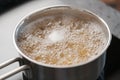 Boiling pasta in a saucepan on home kitchen Royalty Free Stock Photo