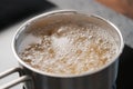 Boiling pasta in a saucepan on home kitchen Royalty Free Stock Photo