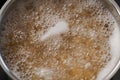 Boiling pasta in a saucepan on home kitchen Royalty Free Stock Photo