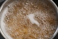 Boiling pasta in a saucepan on home kitchen Royalty Free Stock Photo