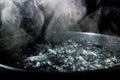 Boiling pot of water with steam