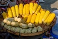 Boiling sweet corn on the cob in wooden tray