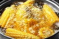 Boiling sweet corn in pan