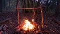 Boiling tea with a pot over a Bushcraft campfire. Primitive survival lean to shelter in the Blue Ridge Mountains of Asheville, Nor Royalty Free Stock Photo