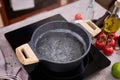 Boiling water in a cooking pot an a pan on a induction stove at domestic kitchen Royalty Free Stock Photo