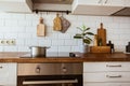 Boiling water in a cooking pot an a pan on a induction stove in the modern white kitchen Royalty Free Stock Photo