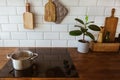 Boiling water in a cooking pot an a pan on a induction stove in the modern white kitchen Royalty Free Stock Photo