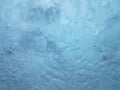 Boiling water drops. Attractive natural turquoise blue underwater colors. Beautiful texture of the movement of the waves