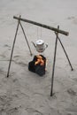 boiling water kettle on wood campfire by beach. Royalty Free Stock Photo