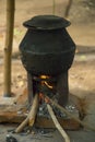 Boiling water on an open fire with Wood burning Cook Stove or The Rural Stove in a rural Indian village Tamil Nadu in India Royalty Free Stock Photo
