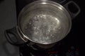 Boiling water in pan on electric stove in the kitchen Royalty Free Stock Photo