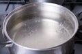 Boiling water in pan on stove in the kitchen Royalty Free Stock Photo