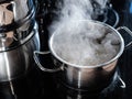 boiling water in saucepan on ceramic stove at home Royalty Free Stock Photo