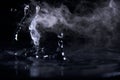 Boiling water splash with steam on black background closeup Royalty Free Stock Photo