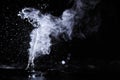 Boiling water splash with steam on black background closeup Royalty Free Stock Photo