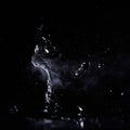 Boiling water splash with steam on black background closeup Royalty Free Stock Photo