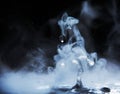 Boiling water splash with steam on black background closeup Royalty Free Stock Photo