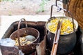 Boiling White and Yellow silkworm cocoons in the pot to make Silk Thread, Boil Silk Nest with Silk Reeling Royalty Free Stock Photo