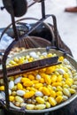 Boiling White and Yellow silkworm cocoons in the pot to make Silk Thread, Boil Silk Nest with Silk Reeling Royalty Free Stock Photo