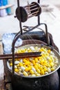 Boiling White and Yellow silkworm cocoons in the pot to make Silk Thread, Boil Silk Nest with Silk Reeling Royalty Free Stock Photo