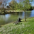 Bois de Vincennes in spring, view of the lake and the daisies of the biggest public park of Paris Royalty Free Stock Photo