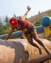 BOISE, IDAHO/USA - AUGUST 10: Runner 7317 dressed in a Mario outfit jumps over and obstacle at the The Dirty Dash in Boise, Idaho